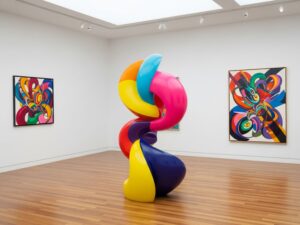 An abstract contemporary art sculpture with vibrant colors in a gallery setting. Image meta description: A modern art piece showcasing the diverse and often colorful nature of contemporary art.